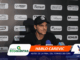 Man in a black cap speaks at a press conference with a sponsor-backed backdrop; lower third shows 'HABLÓ CAREVIC' and 'ANTES DE LA FINAL DEL TORNEO DE COPA' visuals.