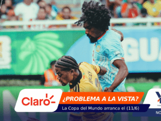 Two soccer players clash for the ball on a crowded stadium field, one in blue and one in yellow, with sponsor banners overlaid at the bottom and a blurred crowd in the background.