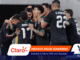 Mexican national football team players celebrate in a huddle on the field, arms around each other.