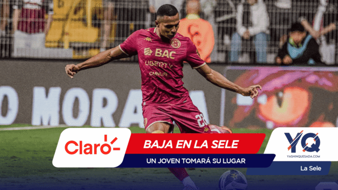 Soccer player in a pink kit kicking a ball during a match, with advertisements and spectators in the background.