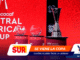 Red backdrop with CONCACAF Central American Cup text and a silver trophy on a podium, suggesting a trophy presentation event.