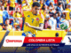 Colombian soccer player in a yellow jersey with number 7 sprinting for the ball as a cheering crowd watches from the stands.