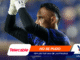 Soccer goalkeeper raising gloved hands in celebration, with bold brand banners overlaying the scene