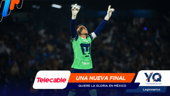 Soccer goalkeeper in a neon-green kit raises both arms in celebration on the pitch, with sponsor banners across the bottom edge.