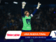 Soccer goalkeeper in a neon-green kit raises both arms in celebration on the pitch, with sponsor banners across the bottom edge.