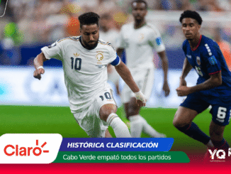 Soccer match: Saudi Arabia player wearing white with number 10 controls the ball as a blue-clad opponent pursues, with sponsor graphics overlay at the bottom.