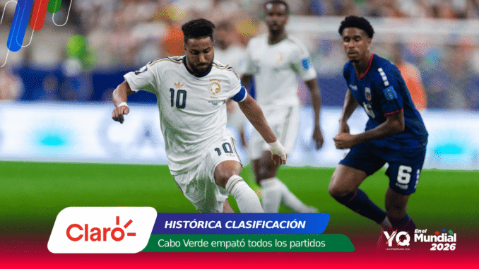 Soccer match: Saudi Arabia player wearing white with number 10 controls the ball as a blue-clad opponent pursues, with sponsor graphics overlay at the bottom.