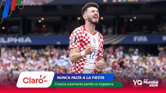 Croatian soccer player in a red-and-white checkered jersey celebrating a goal on a packed stadium field.