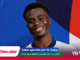 Smiling football player on a colorful promotional banner for the 2026 World Cup with the Telecable logo.