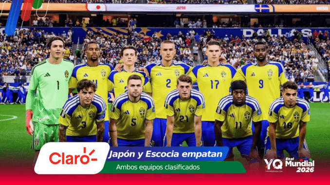 Swedish national football team players pose for a group photo on the pitch before a match, wearing yellow jerseys with blue trim; goalkeeper in green stands at left, stadium crowd in background.