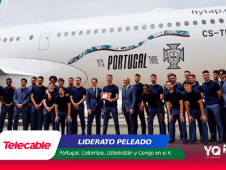 Group of Portuguese football players in navy outfits posing together on a runway beside a white airplane with 'It's PORTUGAL TIME' graphics and the Portuguese flag.