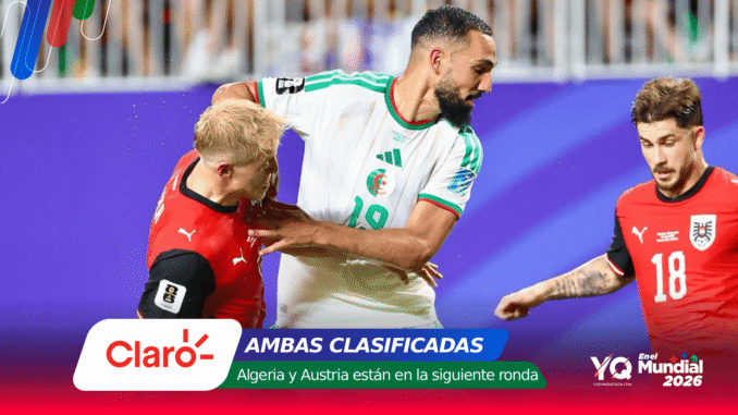 Soccer players in red and white compete for the ball on a purple advertising background in a stadium.