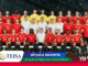 Belgian national football team posing for a full group photo in red home kits and yellow goalkeepers inside a stadium.