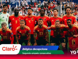 Belgium national football team posing for a group photo on the pitch, goalkeeper in green on the left, red jerseys throughout.