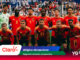 Belgium national football team posing for a group photo on the pitch, goalkeeper in green on the left, red jerseys throughout.