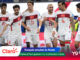 Turkish national football players celebrate on the field after a win, wearing white kits with red flags, with colorful sponsor banners in the foreground (Claro, Mundial 2026).