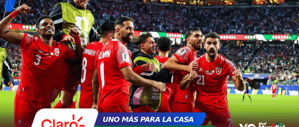 Red-clad soccer players celebrate together on the field as a full stadium cheers behind them, bannered with sponsor logos.