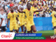 Soccer players on a field celebrate, wearing yellow and white uniforms with a packed stadium in the background and Claro branding overlayed in the foreground.