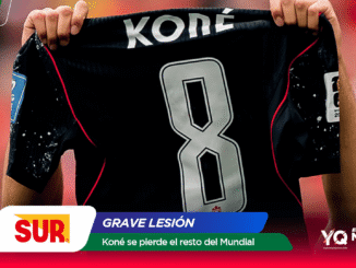 Soccer player holds up a black jersey with the large number 8 and the name KONÉ on it.