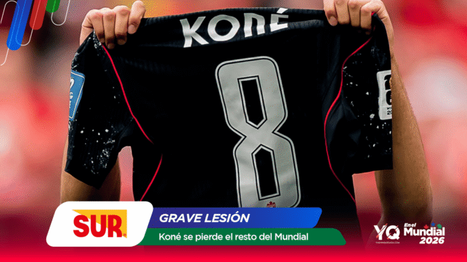 Soccer player holds up a black jersey with the large number 8 and the name KONÉ on it.
