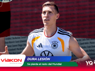 Football player in a white Germany jersey running on the field with sponsor banners at the bottom, including 'Dura Lesión' and 'Se pierde el resto del Mundial' text.
