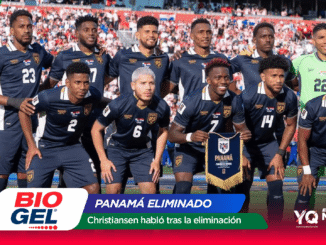 Panama national football team posing for a group photo on the field after a match, players in navy uniforms with crest, crowd in background, banner reads 'Panamá Eliminado'