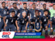 Panama national football team posing for a group photo on the field after a match, players in navy uniforms with crest, crowd in background, banner reads 'Panamá Eliminado'