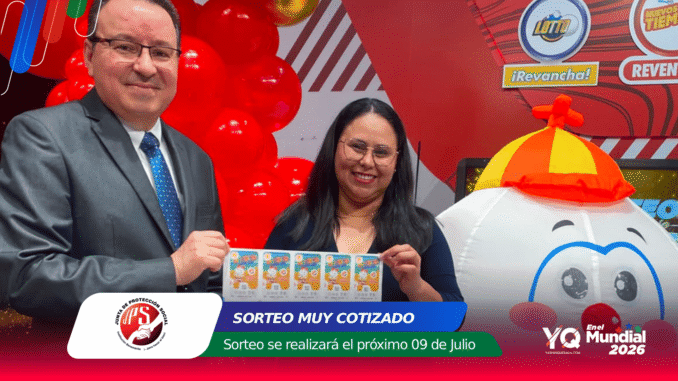 Man in a gray suit and a woman with glasses hold a sheet of colorful raffle tickets at an event, with red balloons and a cartoon snowman balloon in the background.