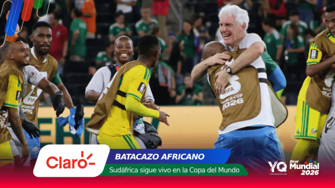Soccer players in yellow uniforms celebrate on the field as a white-haired man hugs a teammate; bottom shows Claro banner and World Cup 2026 branding.