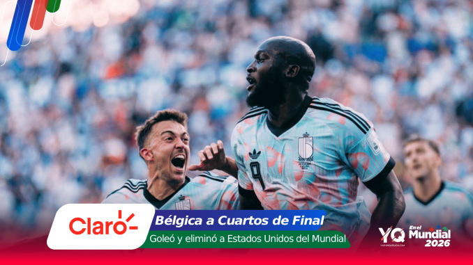 Two soccer players celebrate on the field during a match, team jerseys light blue with black stripes, crowd in the background.