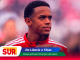 Portrait of a man in a red athletic jacket on a news banner with SUR logo and headline 'De Liberia a Tibás'