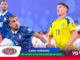 Two soccer players battle for the ball on the field, one in blue France kit and the other in yellow Sweden kit, with Roma branding nearby in the foreground.