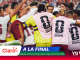 Soccer players huddle in celebration on the field, wearing pink bibs with FIFA World Cup 2026 logos and Claro branding.