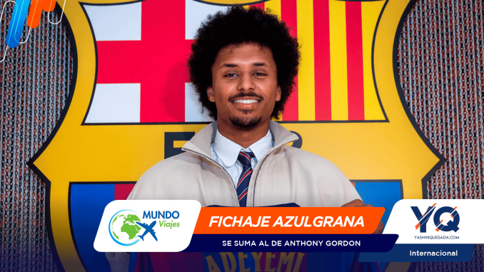 Portrait of a smiling man in a light jacket and striped tie, standing in front of a bold, colorful mural with a lower banner reading 'FICHAJE AZULGRANA' and logos visible at the bottom edge.