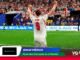 England forward Kane (No. 9) celebrates with fists raised on a green pitch as a packed stadium cheers behind him at the World Cup 2026.