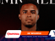 Portrait of a man against a dark gradient background on a comeback banner, with orange 'DE REGRESO' text and sponsor logos at the bottom edge.
