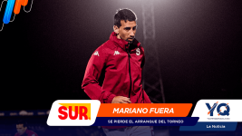 Athlete in a red jacket walking on a dark background with colorful logos at the top-left and sponsor banners across the bottom saying Mariano fuera.