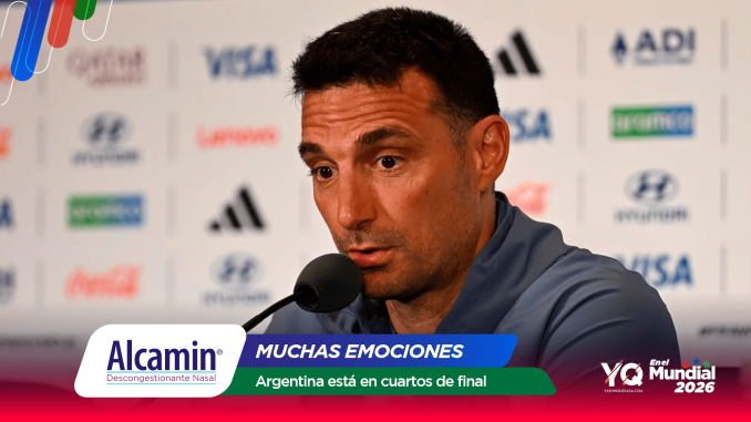 Man at a press conference speaking into a microphone, with sponsor banners in the backdrop and colorful overlay text at the bottom.