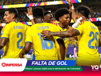 Colombian soccer players in yellow jerseys celebrate a goal on the field with teammates amid a cheering crowd.