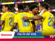 Colombian soccer players in yellow jerseys celebrate a goal on the field with teammates amid a cheering crowd.