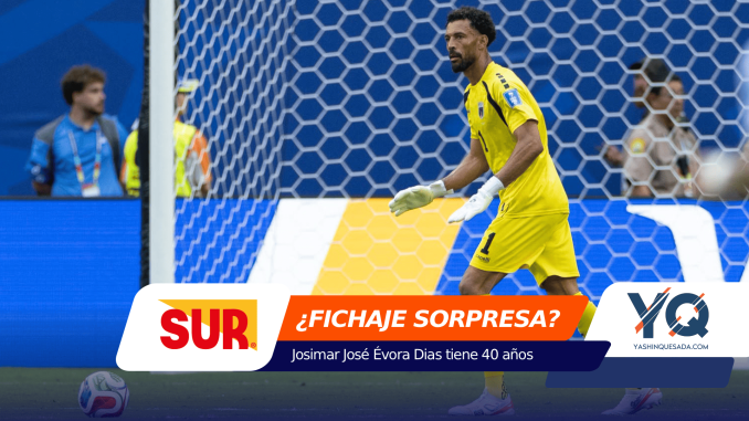Soccer goalkeeper in a bright yellow kit stands in front of the goal with white gloves, blue stadium backdrop and ad banners at the bottom.