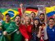 Group of excited soccer fans cheering in a stadium, waving flags from Brazil, Germany, Portugal, Colombia, and the USA.