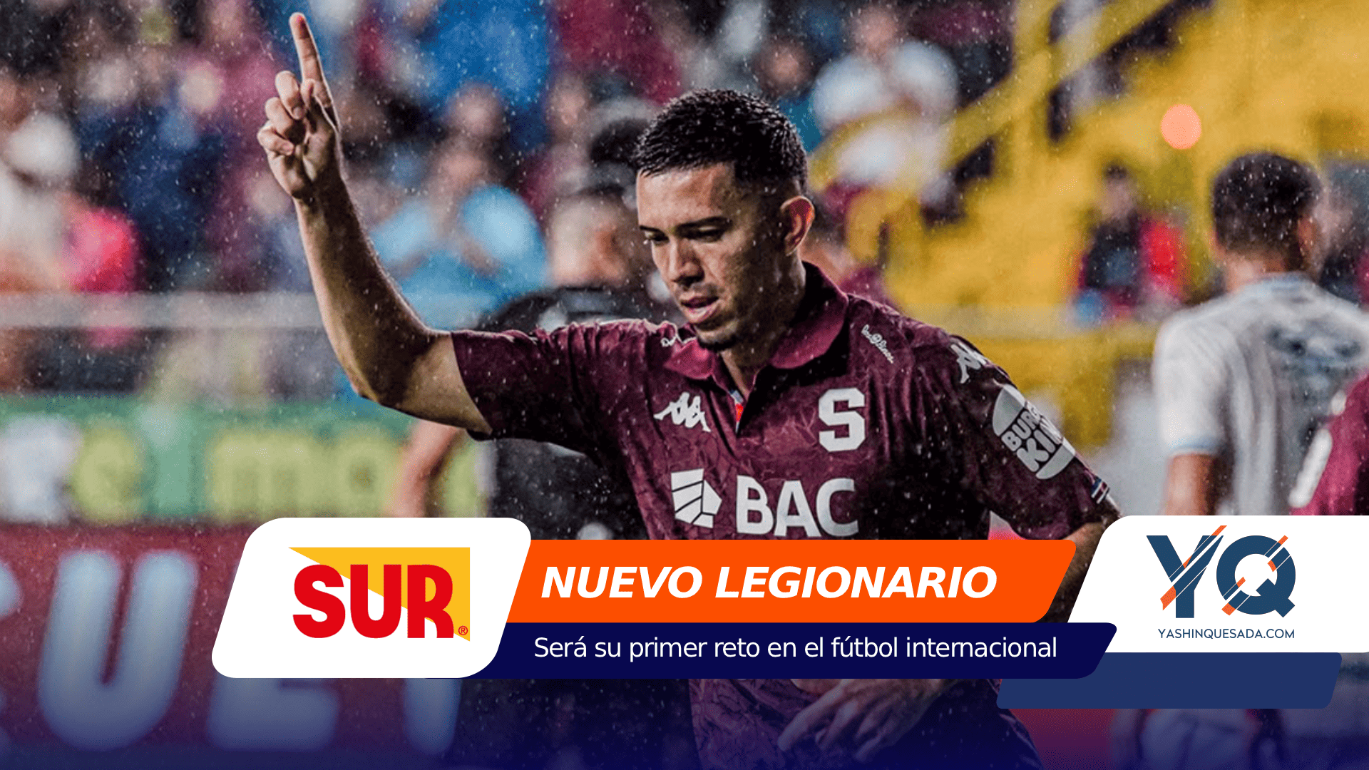 Soccer player in a maroon jersey raises one finger in celebration on a rainy stadium, with colorful sponsor banners at the bottom reading NUEVO LEGIONARIO and related logos in view.