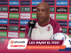 Man in maroon and white sports jersey speaking at a press conference in front of a pink sponsor wall featuring Riyadh Air, Molten, PIF, Aramco logos.