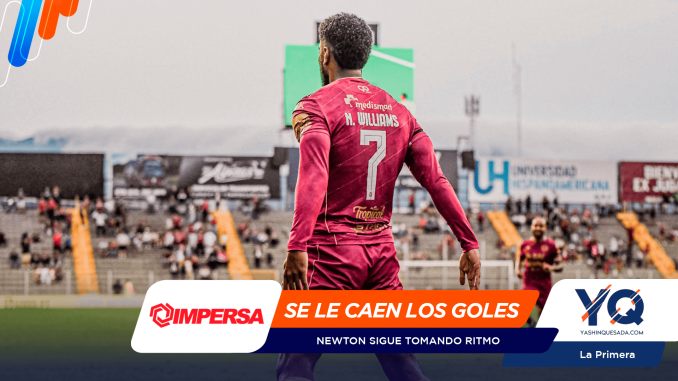 Soccer player in a pink jersey viewed from behind on a stadium field, with large promotional banners in the foreground.