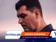 Close-up of a man in profile against a sunset background, overlaid with orange and blue banners reading EXTRALUM and SIGUEN GANANDO.