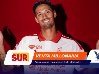 Smiling man in a white and red sports jersey raises his hands against a red background, with promotional banners across the bottom edge.",